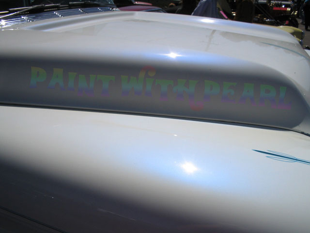 A white car with a Blue "Ghost" custom paint finish