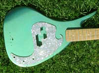 Two pictures of the same Bass Guitar from different angles. Custom painted with Chameleon Green to Blue